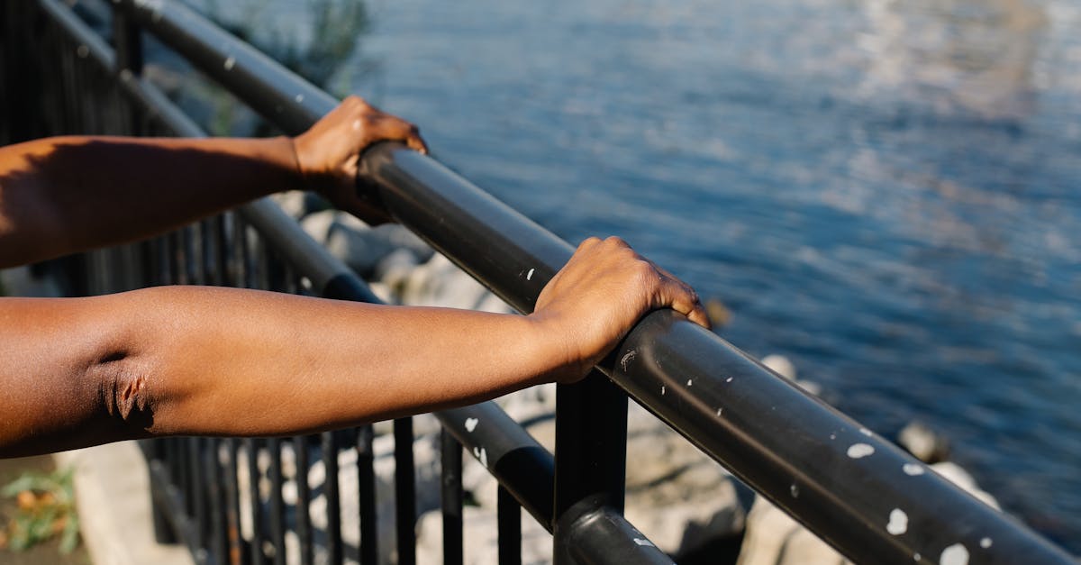 Person Pushing the Stainless Steel Railings · Free Stock Photo