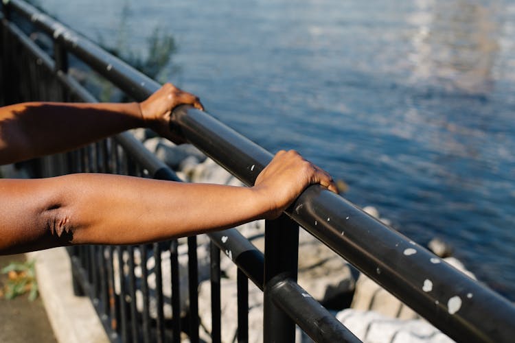 Person Pushing The Stainless Steel Railings