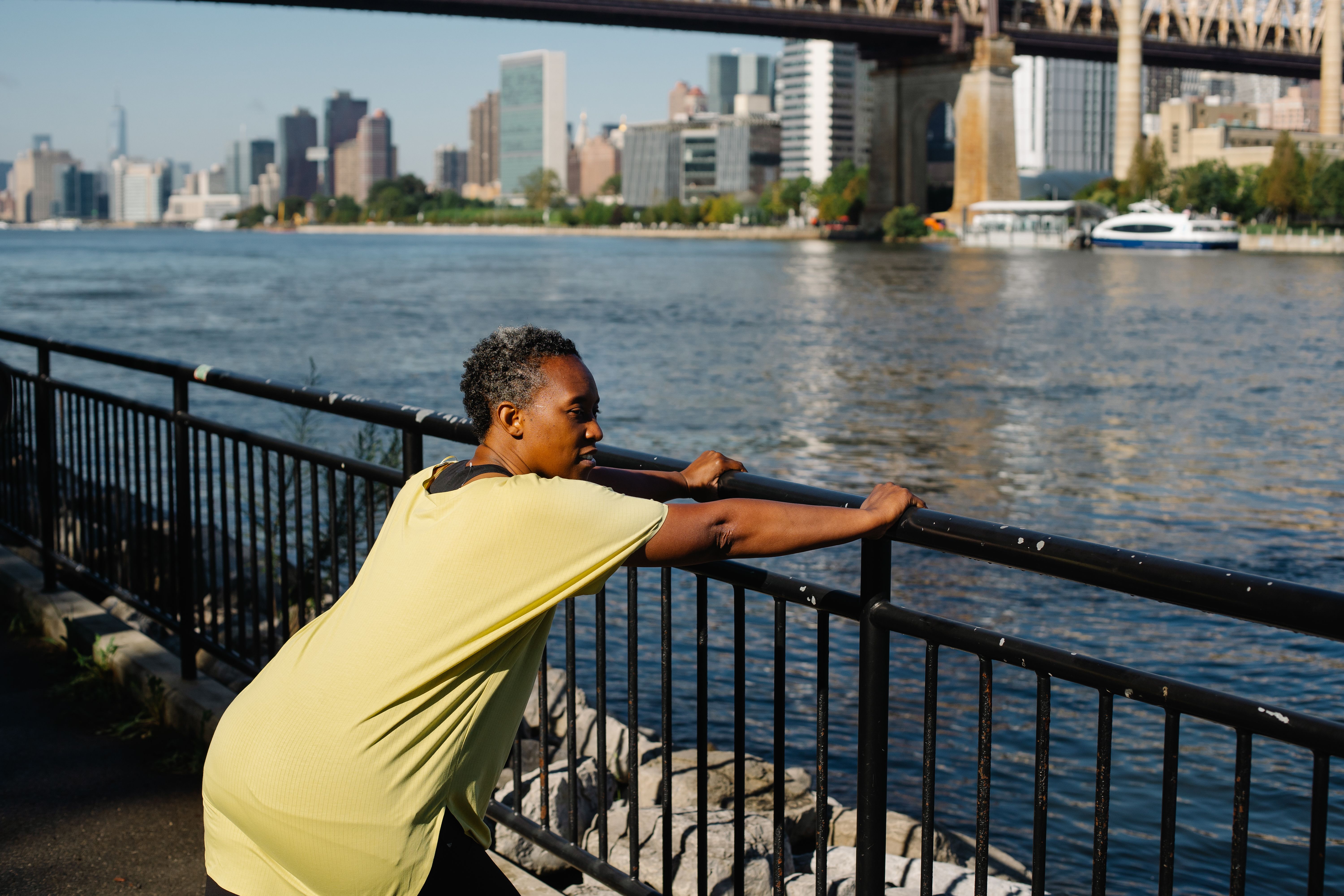 A Woman Holding a Railing While Doing Stretching · Free Stock Photo