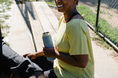 Woman Holding a Water Jug Smiling