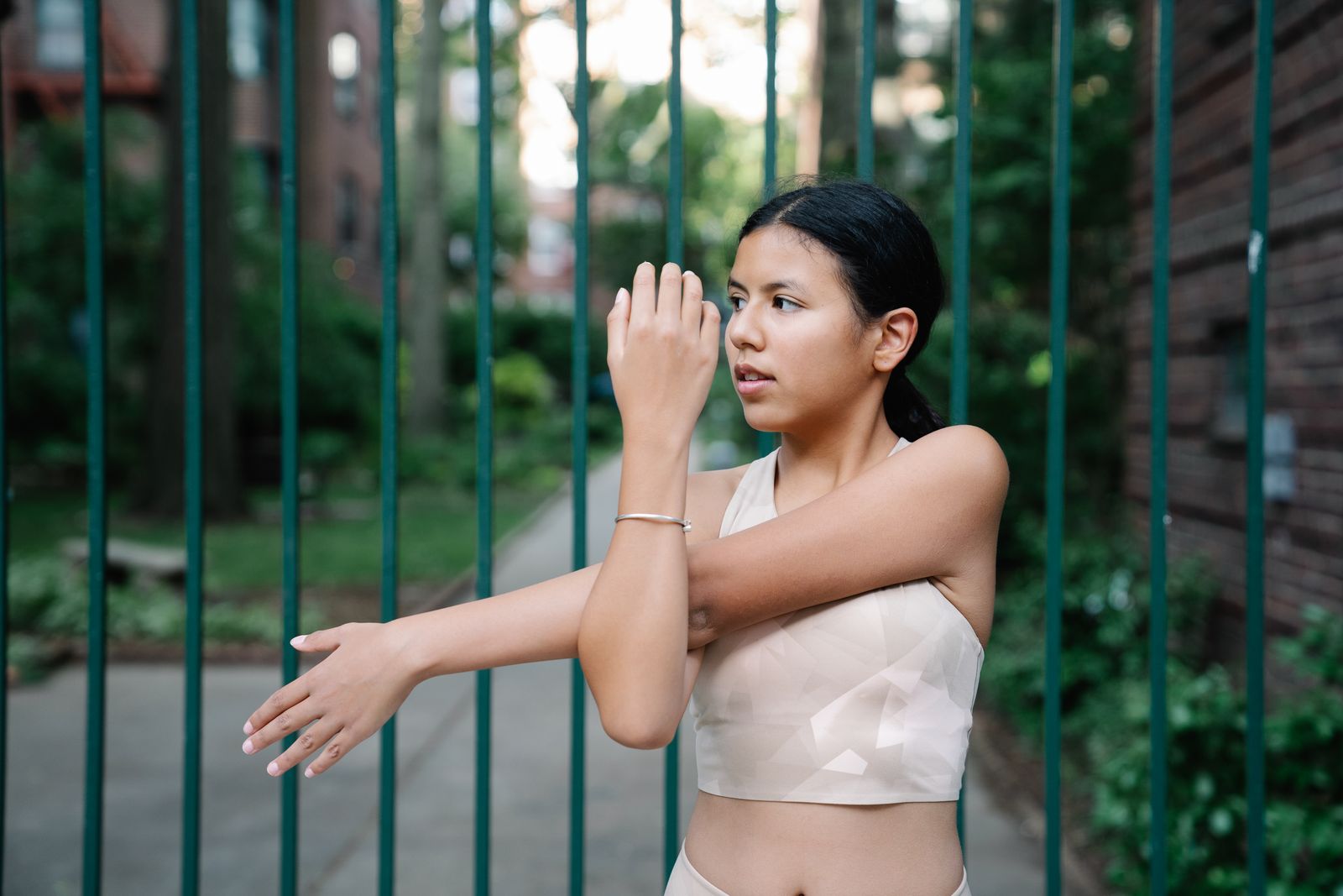 Person adjusting a hand and thumb support in bright natural light