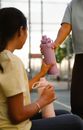 A Person Handing Pink Tumbler to a Woman