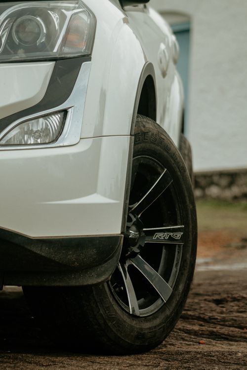 Free Detailed view of a car's front wheel and headlight, emphasizing design and chrome. Stock Photo