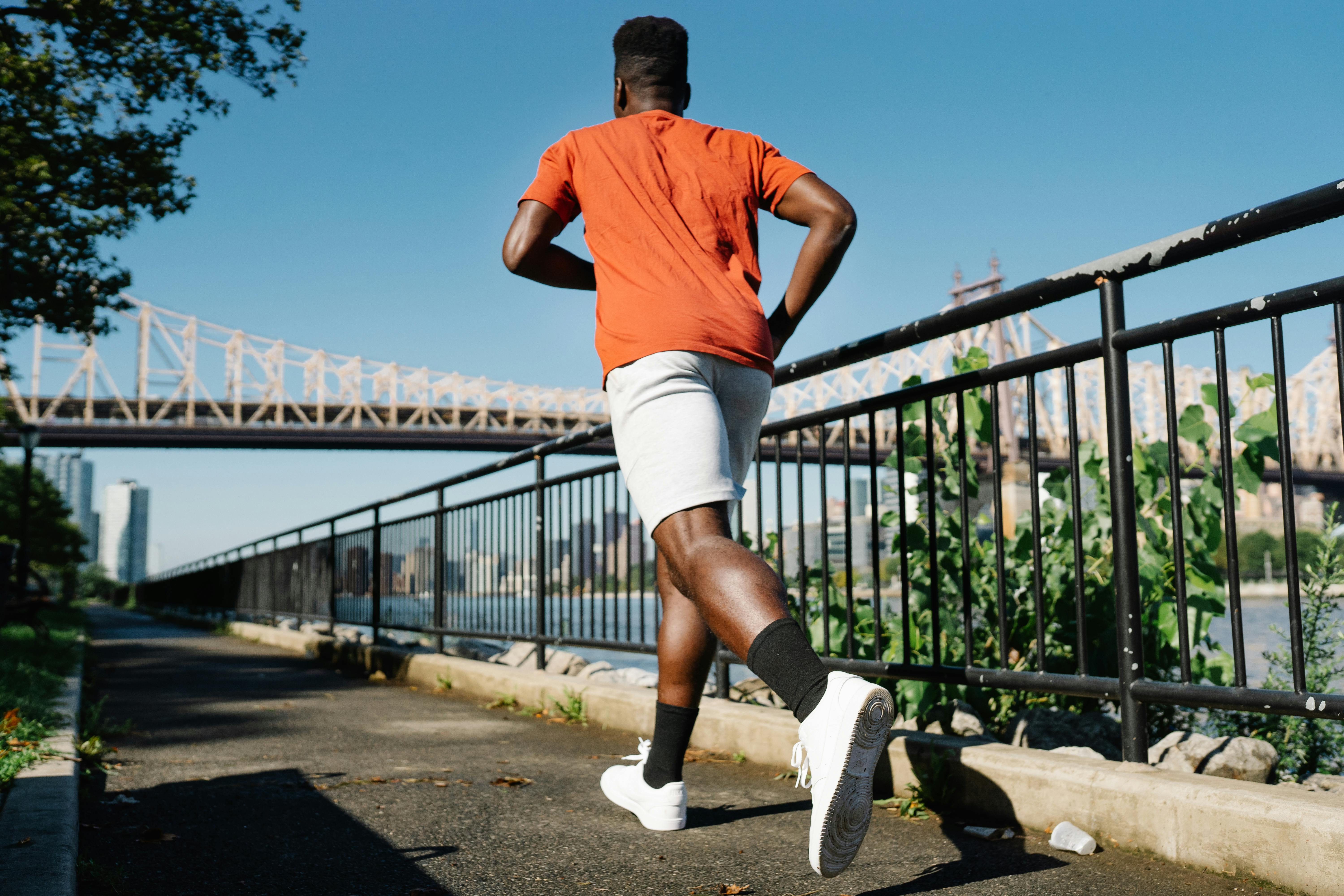 man in orange crew neck t shirt running