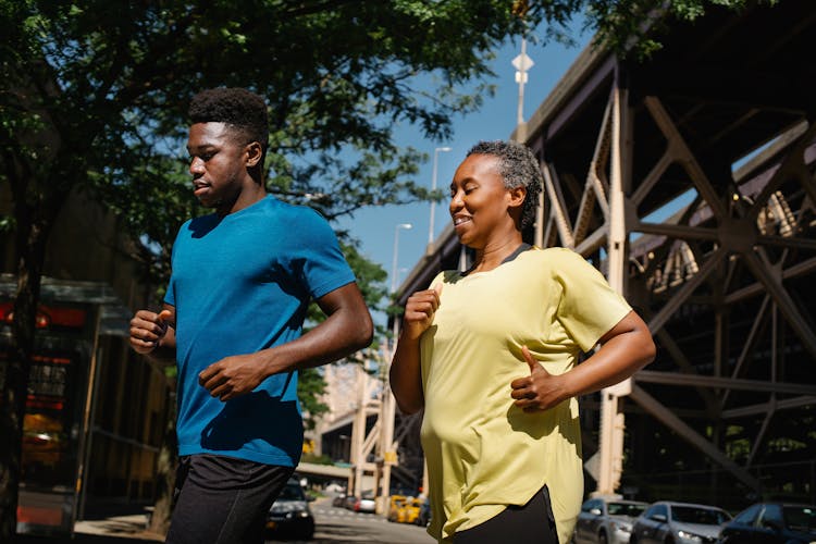 Mother And Son Running In City 