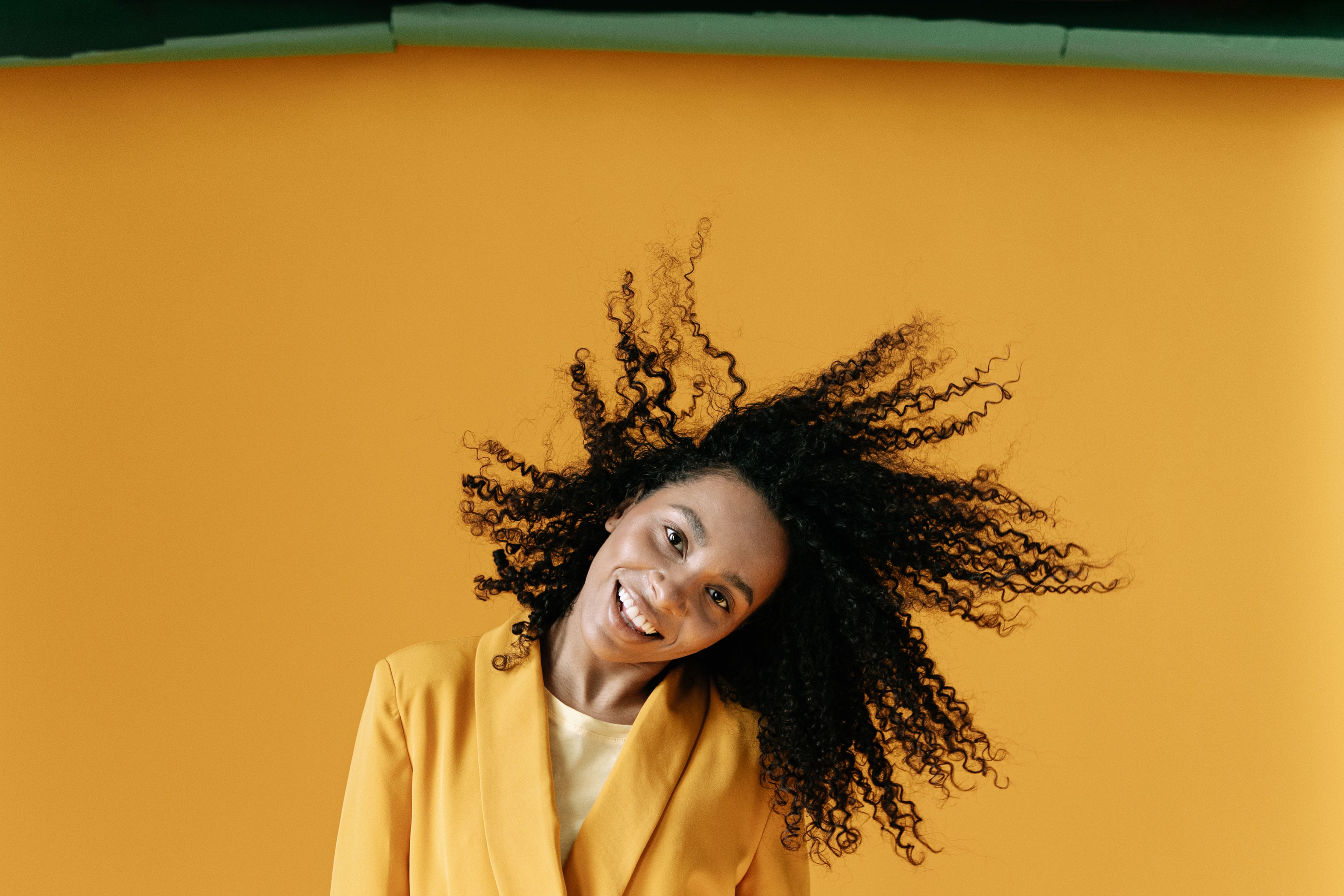 Woman in Yellow Blazer Standing on Yellow Background · Free Stock Photo