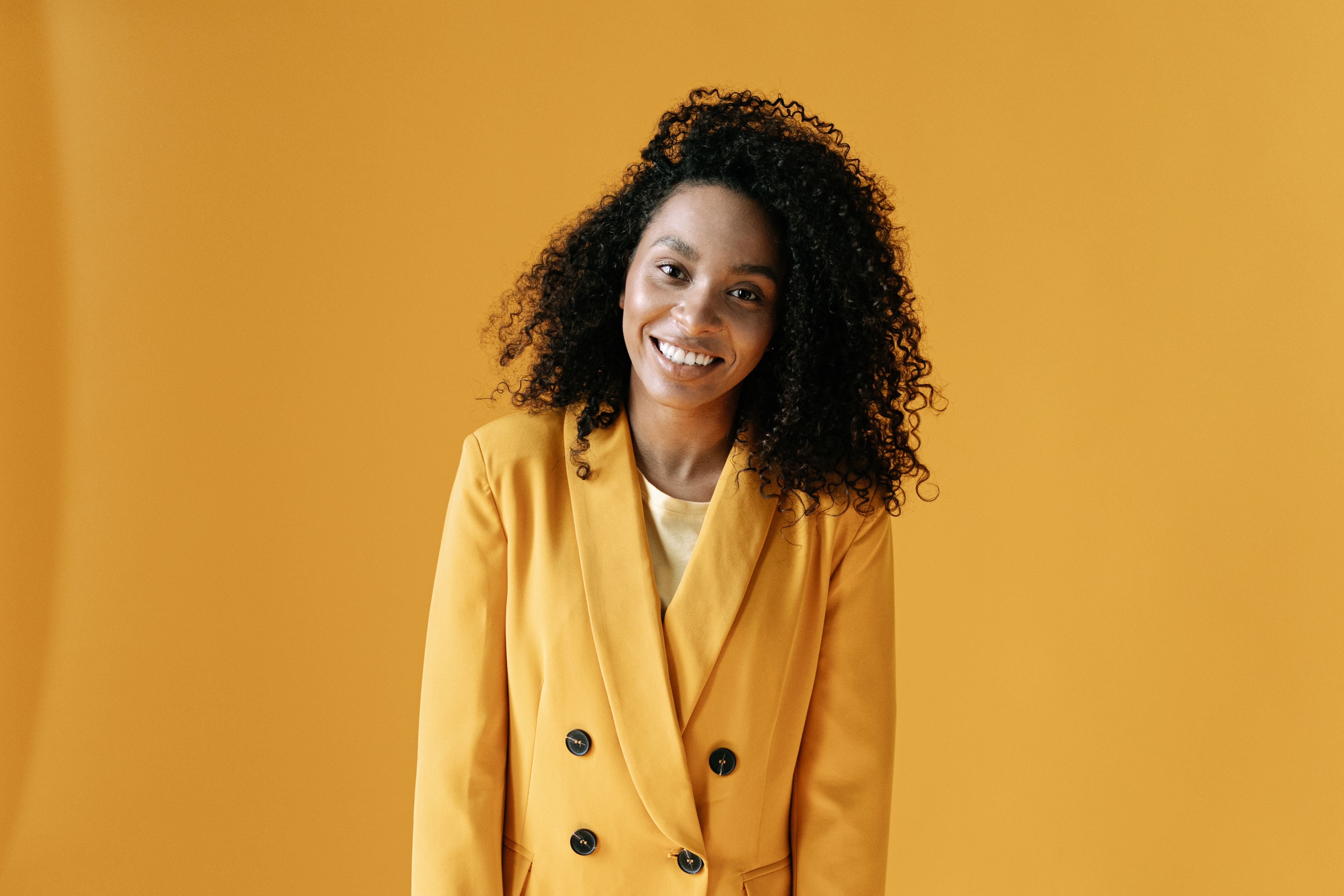 Young Woman in Yellow Blazer Smiling · Free Stock Photo