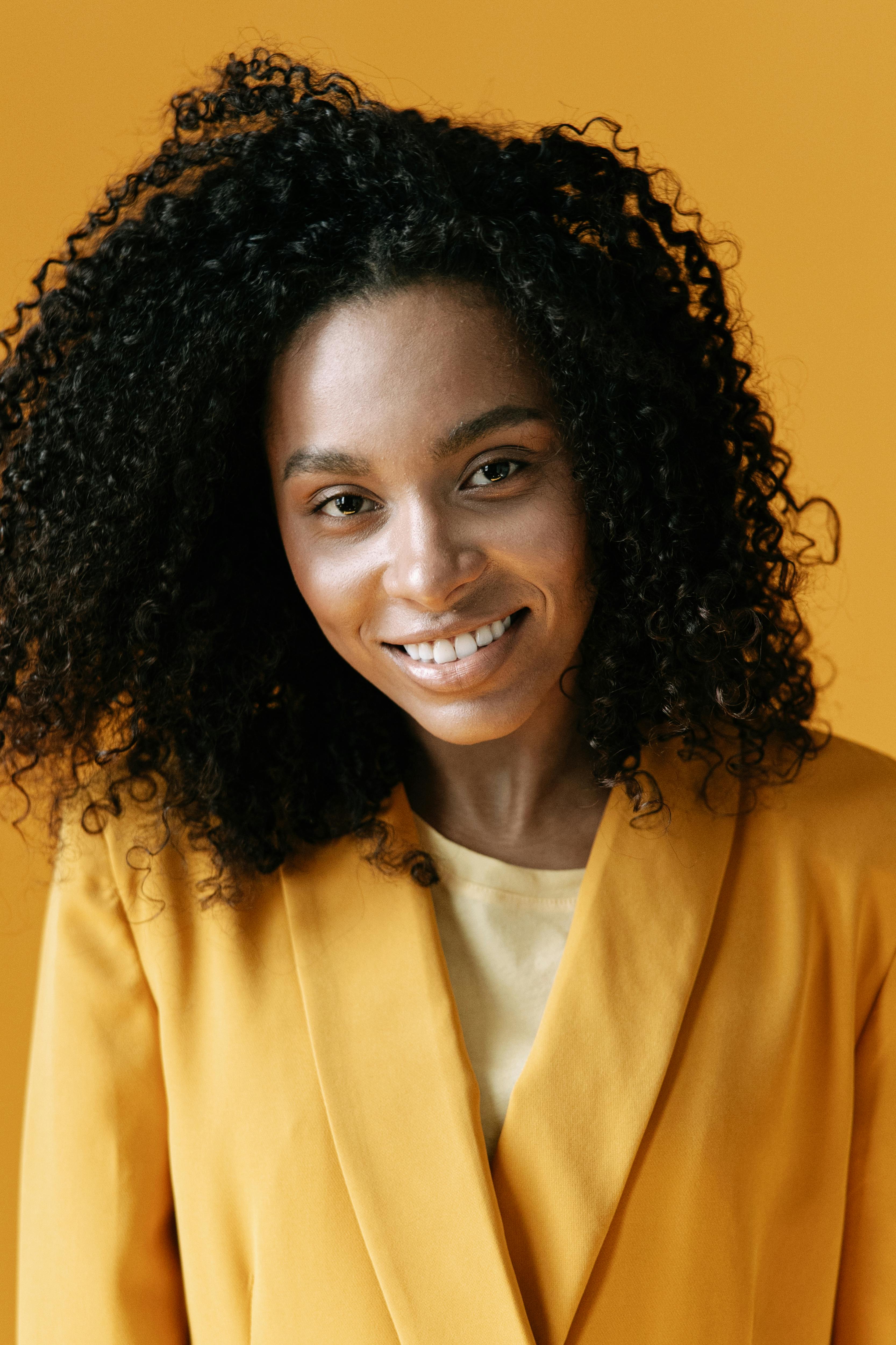 Woman in Yellow Tank Top Touching Her Hair · Free Stock Photo