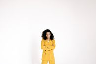 Woman in Yellow Coat Standing