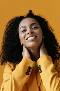 Smiling person in a yellow blazer — photo by Ivan S on Pexels
