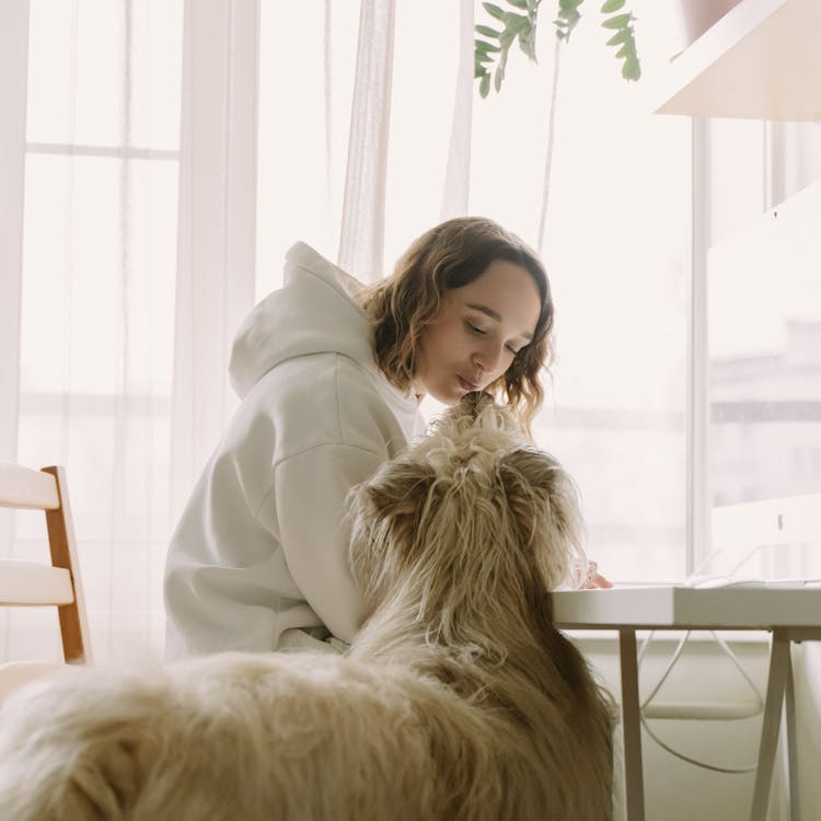 A Woman Kissing Her Pet Dog