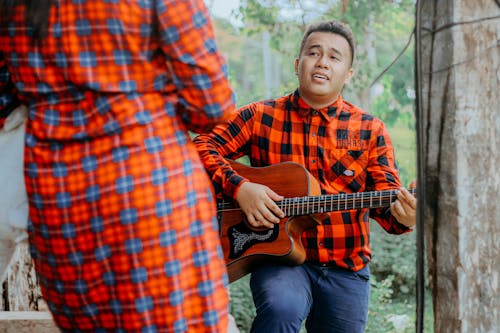 Man Singing While Playing Guitar for a Girlfriend