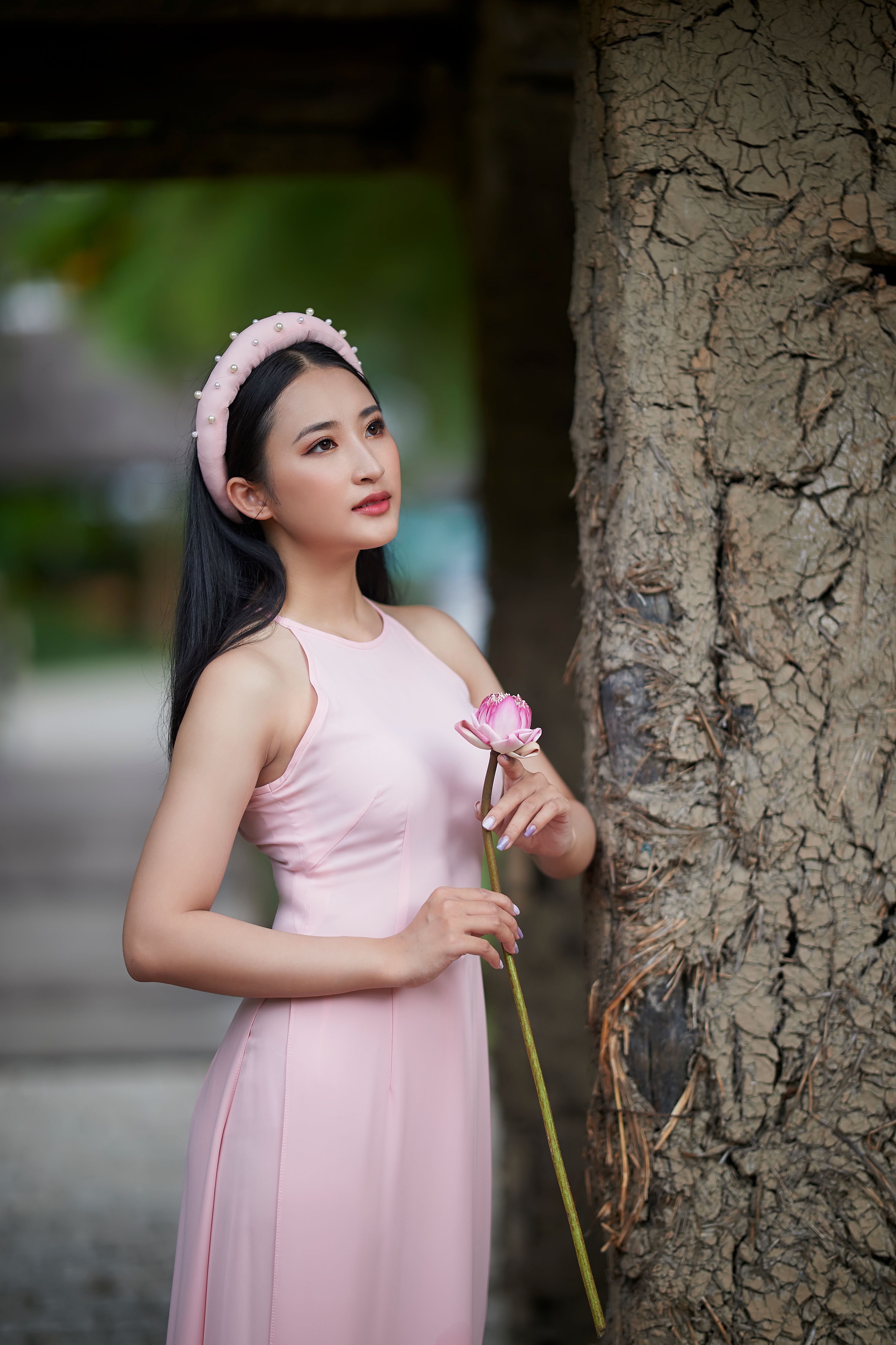 A Woman in Pink Dress Holding a Flower · Free Stock Photo