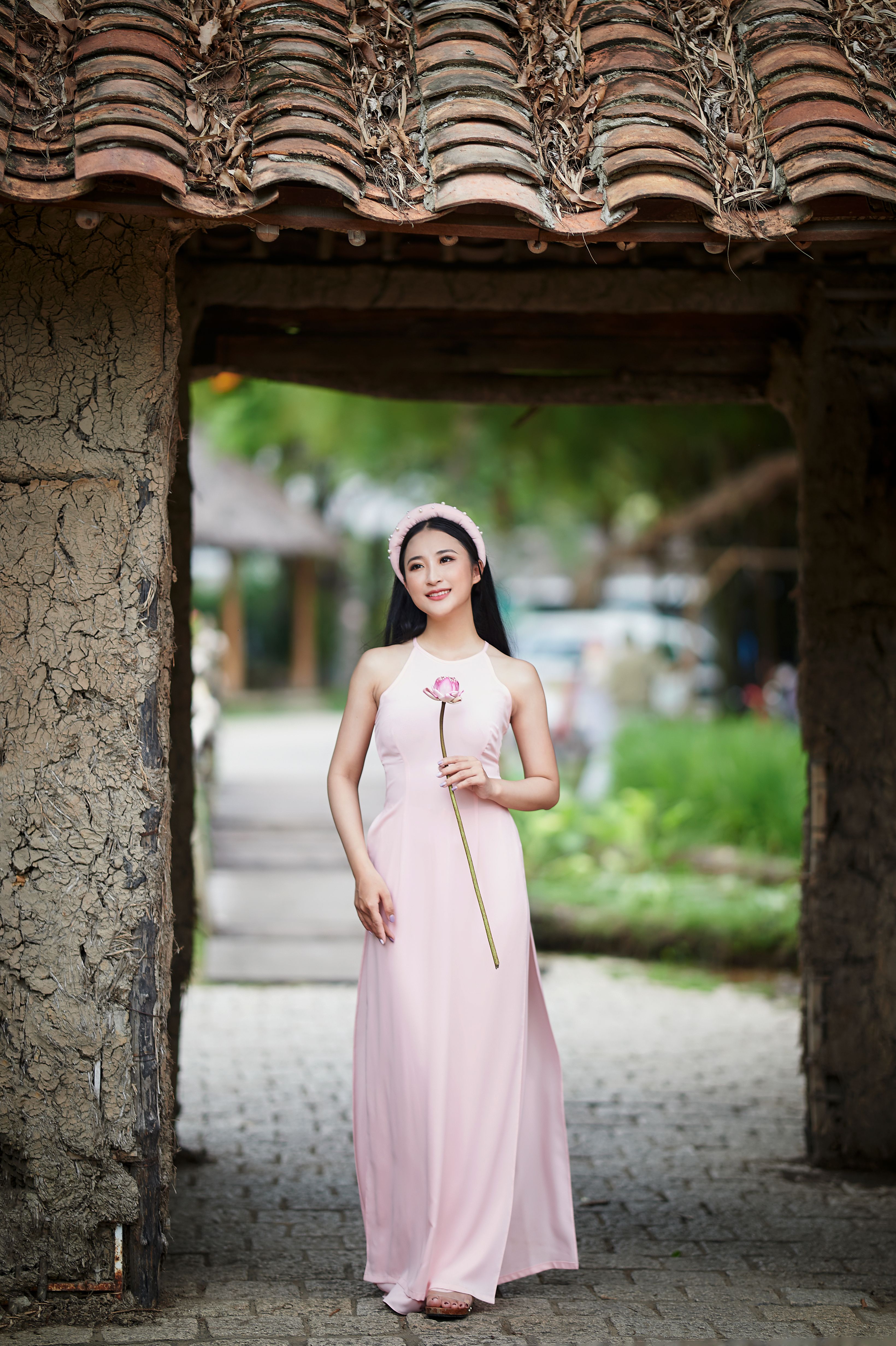 A Woman in Pink Dress Holding a Flower · Free Stock Photo