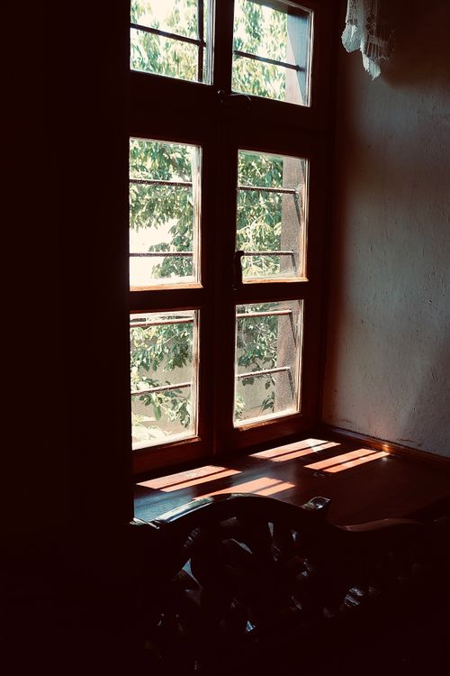 Free Warm sunlight illuminating a room through a vintage wooden window in Elazığ, Turkey. Stock Photo