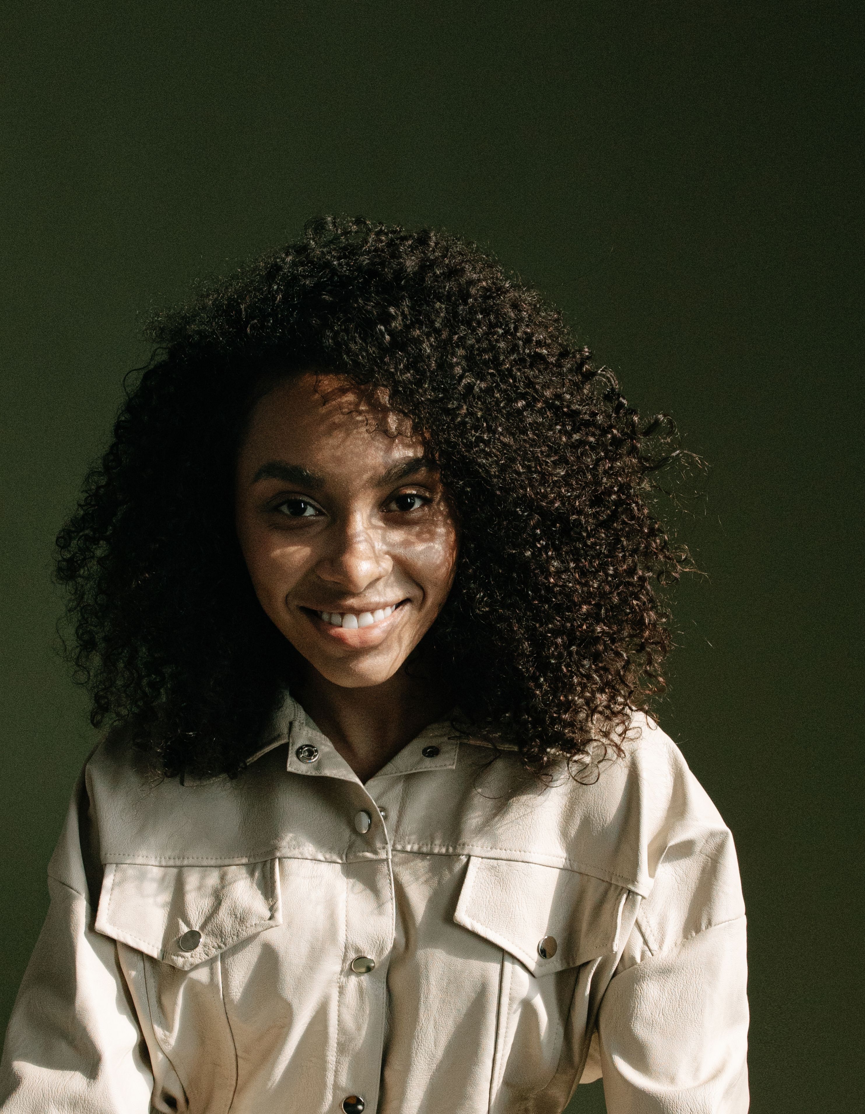 Woman with Curly Hair Smiling · Free Stock Photo