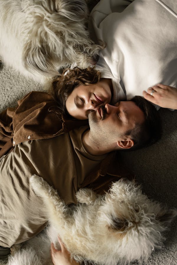 A Couple and Their Dogs Sleeping on the Floor