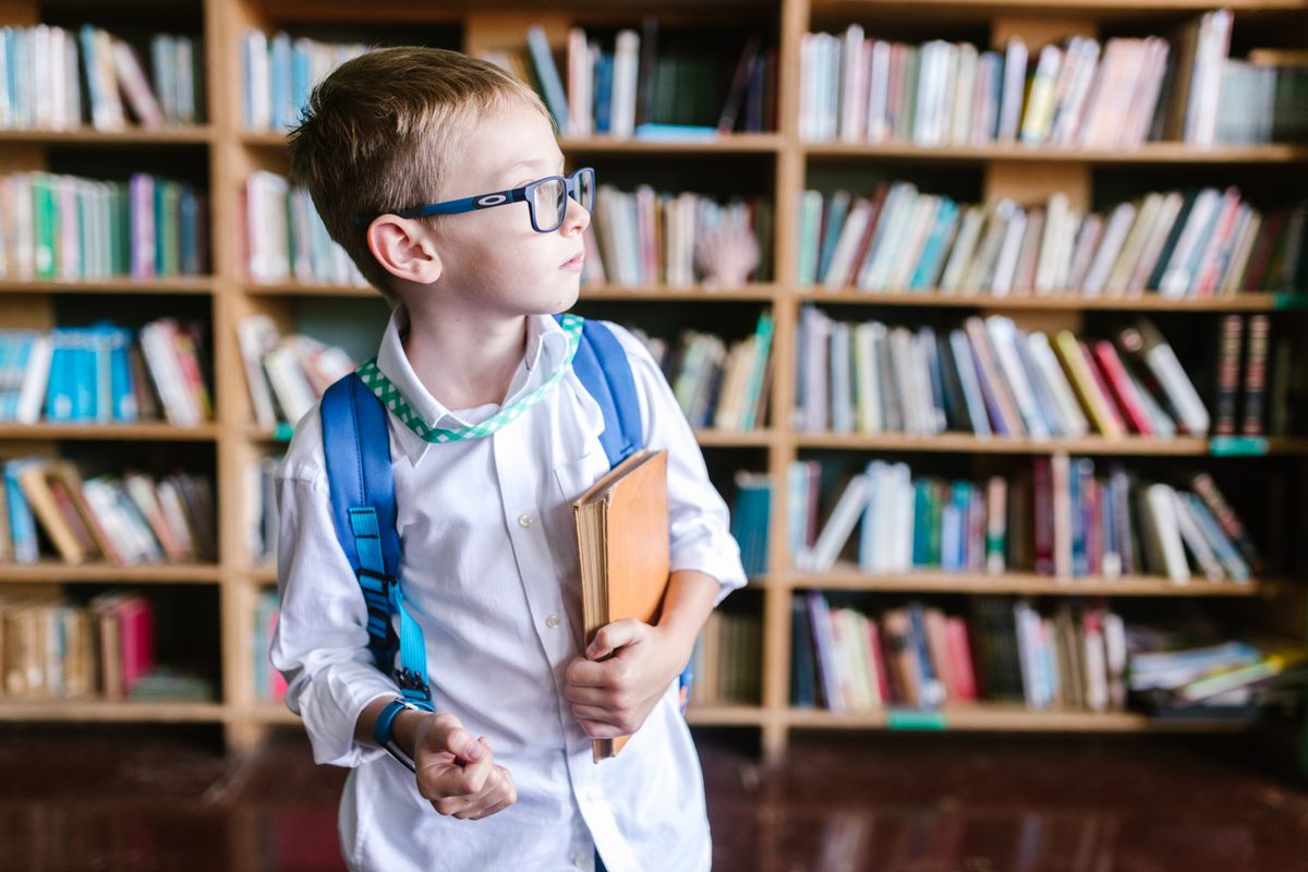 Student in school uniform carrying a backpack