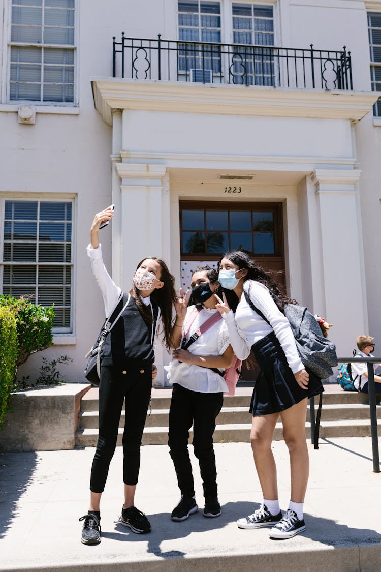 Students Taking Photos Using A Smartphone 