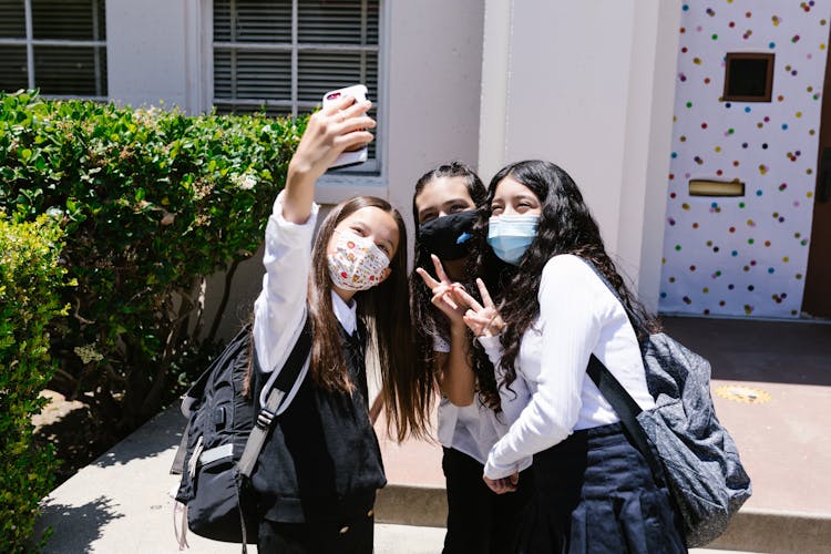 Girls In School Uniform Taking A Group Selfie