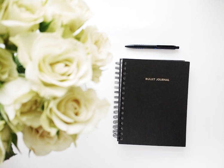 Black Spiral Book On White Surface