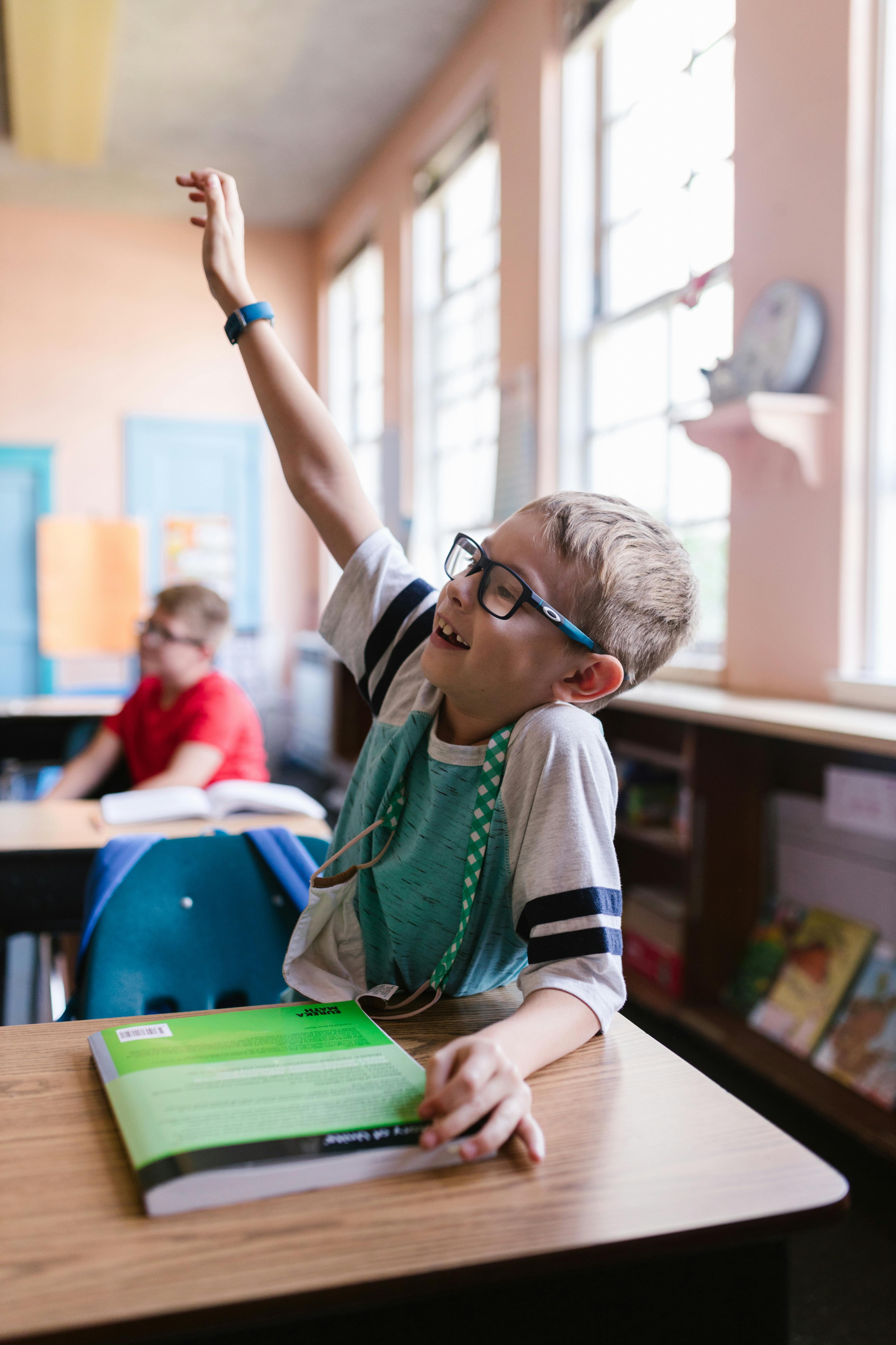 boy in green shirt wearing eyeglasses