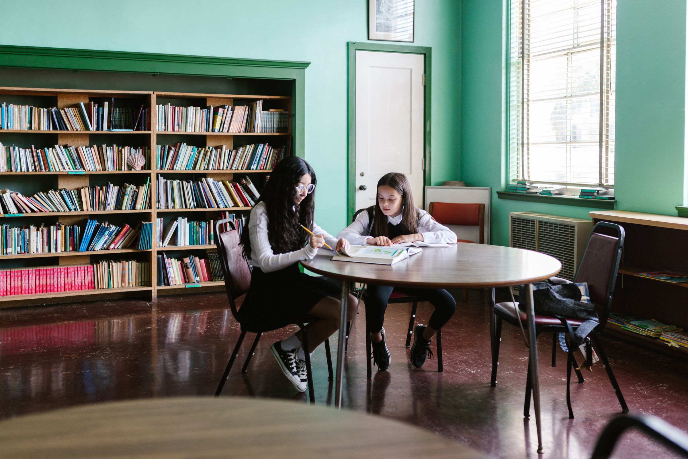 Children reading together in a library
