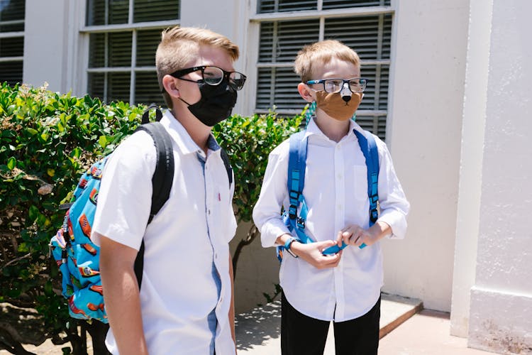 Boys In School Uniform Wearing Face Masks And Eyeglasses 