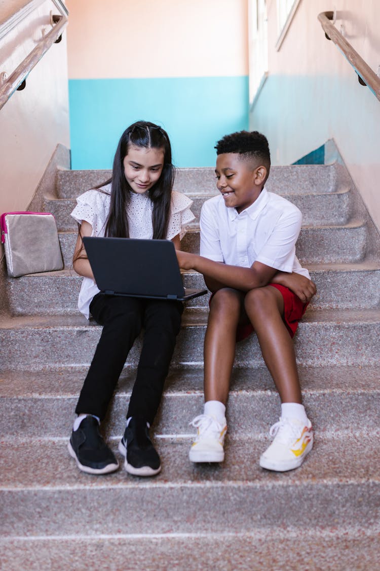 Two Students Using A Laptop