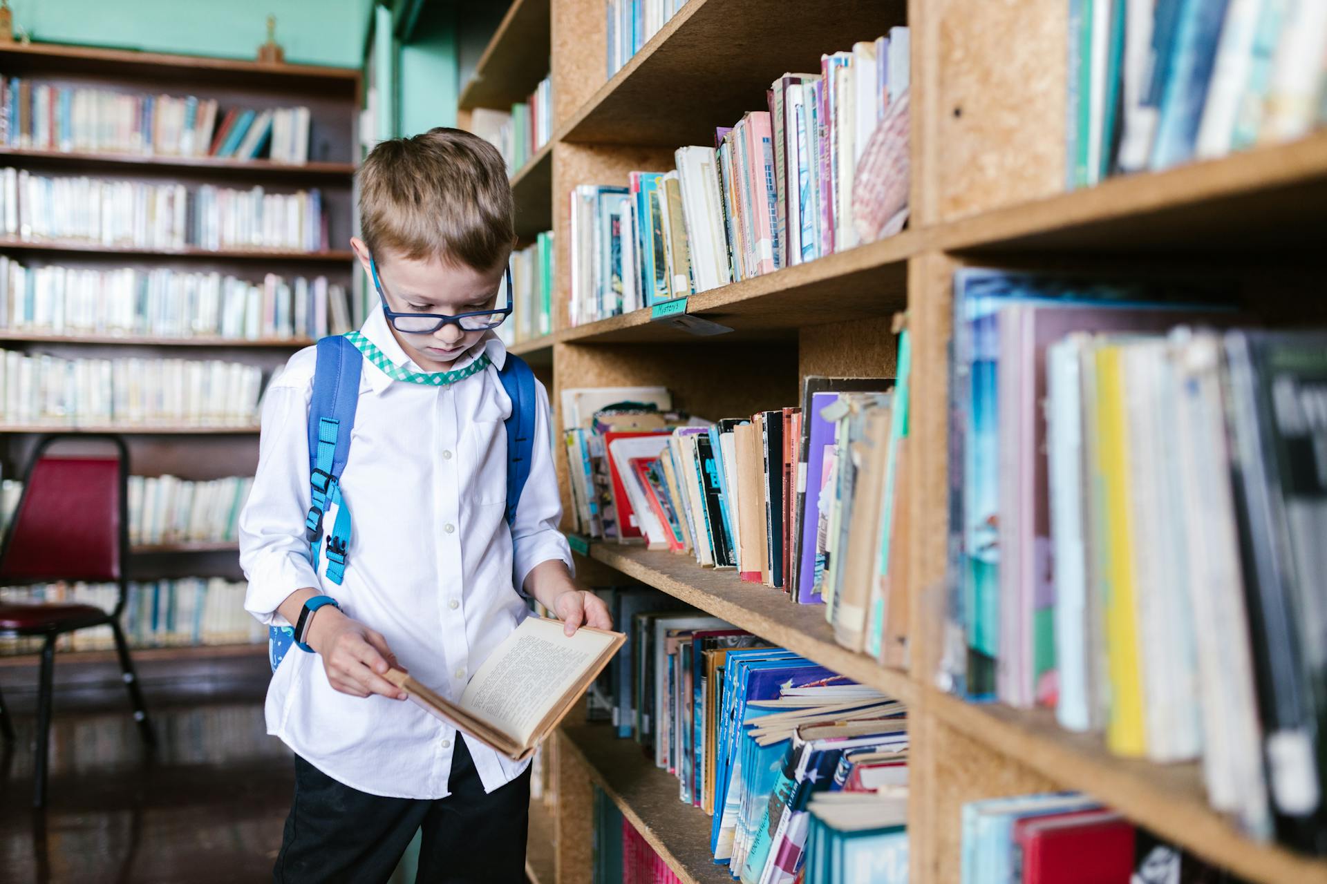 Boy in School Uniform Reading a Book