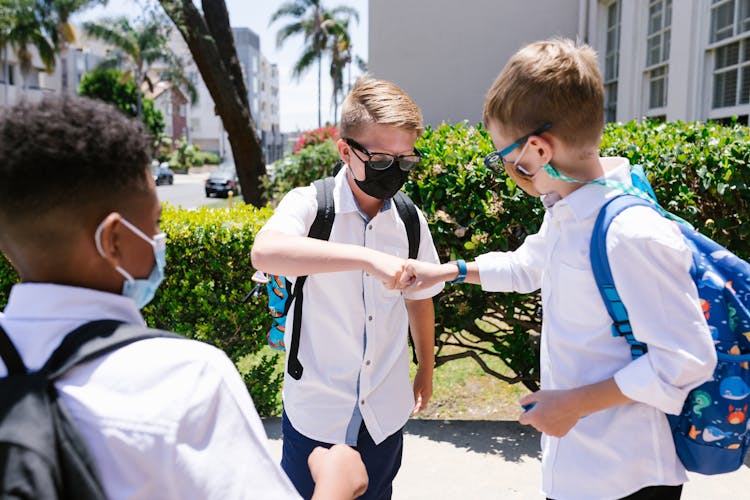 Students Wearing Face Mask Doing Fist Bump