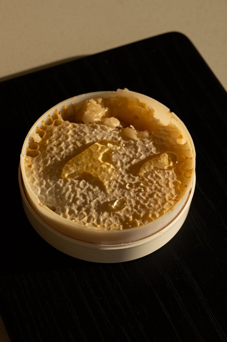 Honey Comb In A Round Plastic Container 