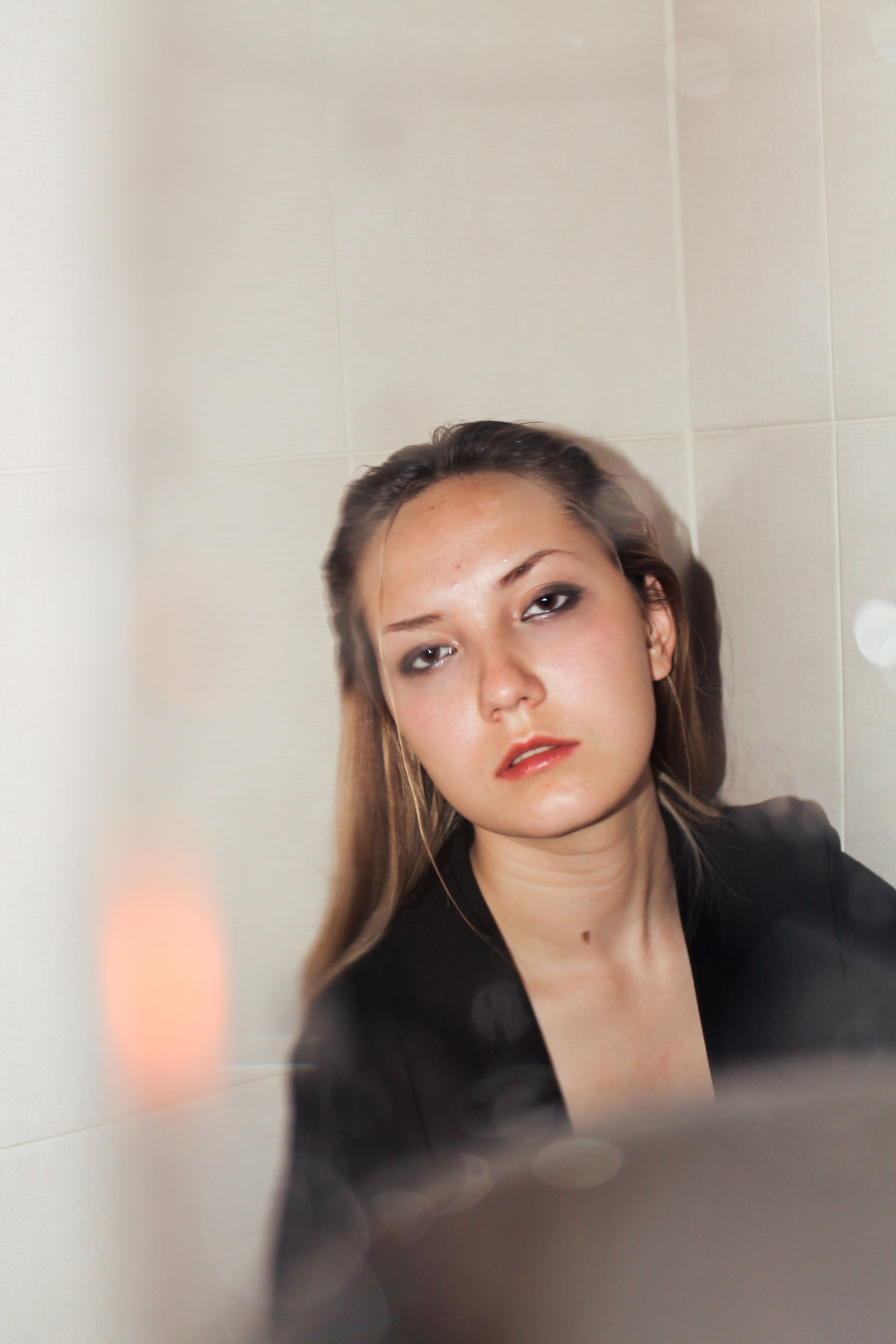 Woman in Black Blazer Leaning on the Wall · Free Stock Photo