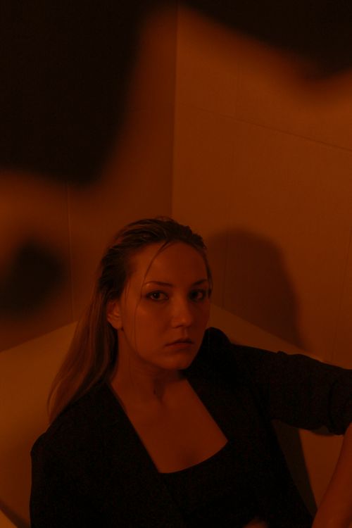 Free A moody portrait of a woman in a bathtub with artistic shadows. Stock Photo