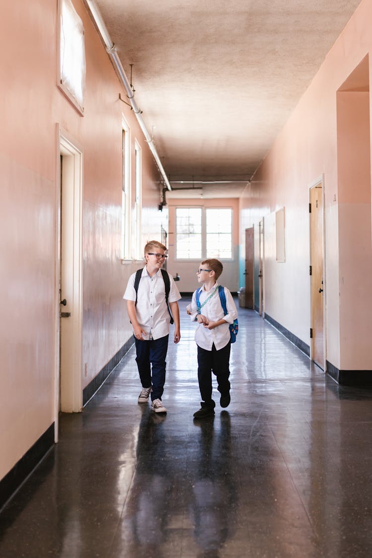 Two Boys Walking In The School