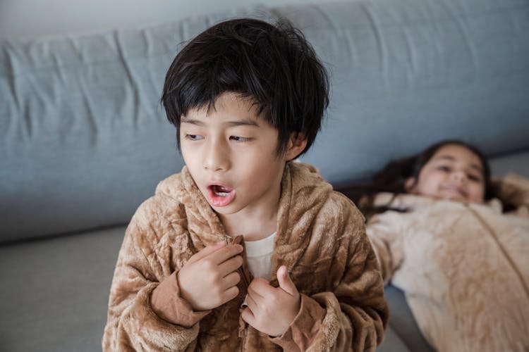 A Boy Wearing A Onesie Yawning