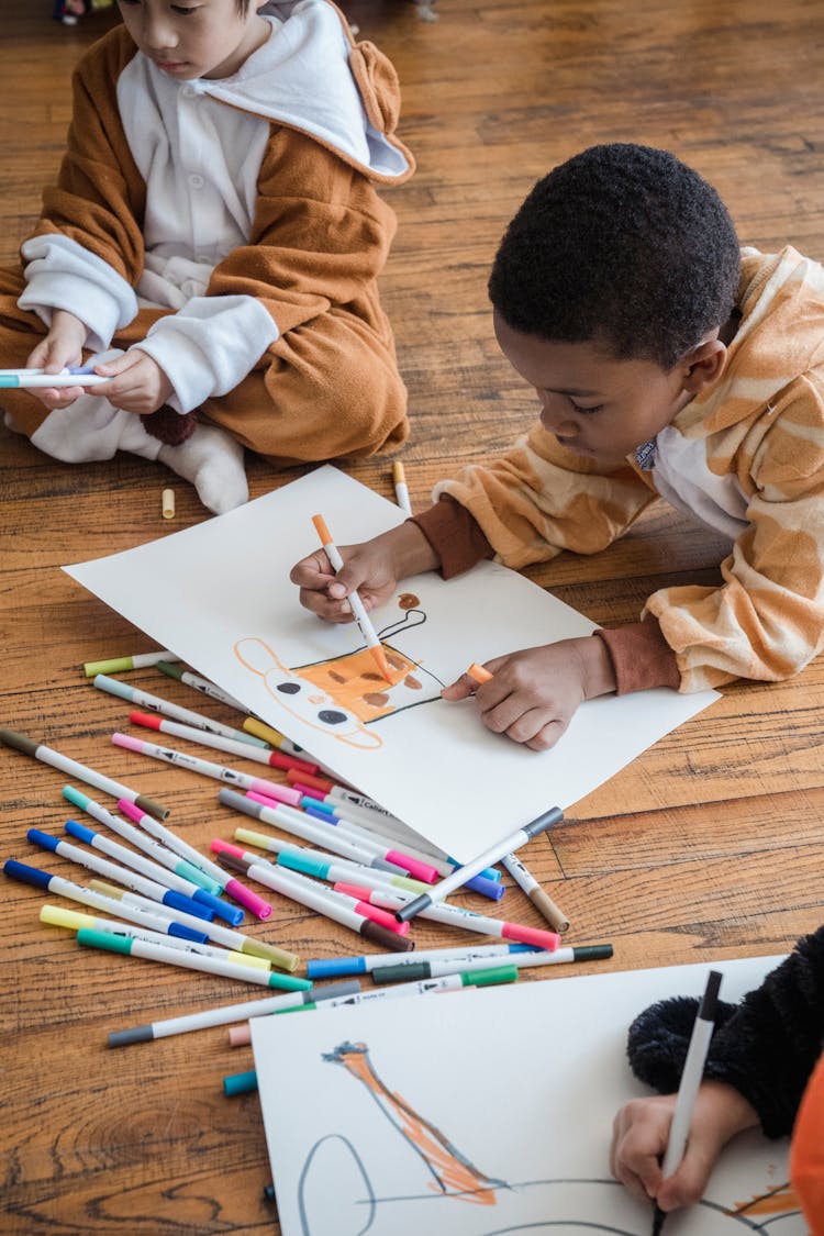 Boy Coloring His Drawing