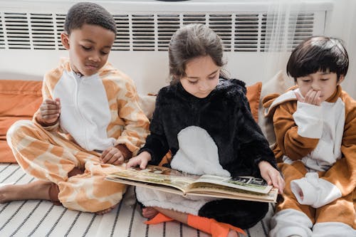 Free Boys and Girl Reading Book Together Stock Photo