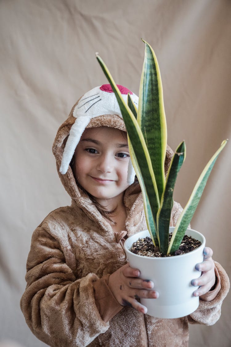 Photo Of A Girl Holding A Plant 