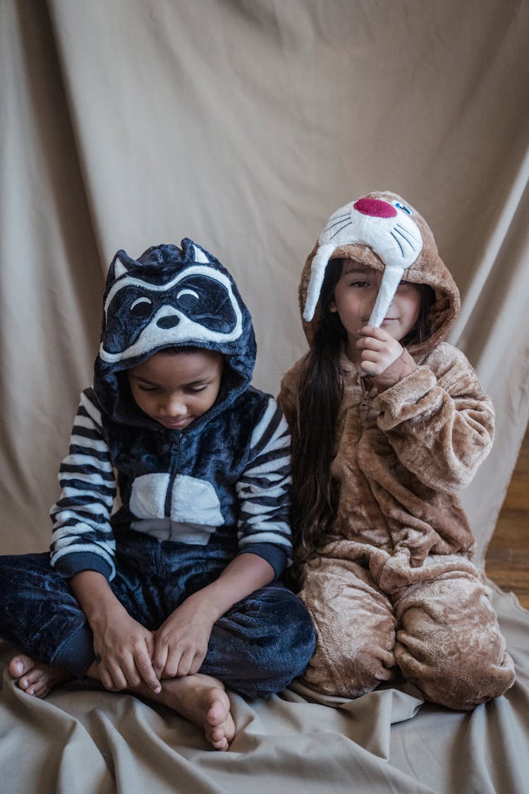 A Girl And A Boy Wearing Onesies