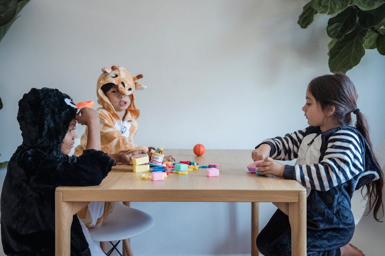 Kids In Onesies Playing With Toys 