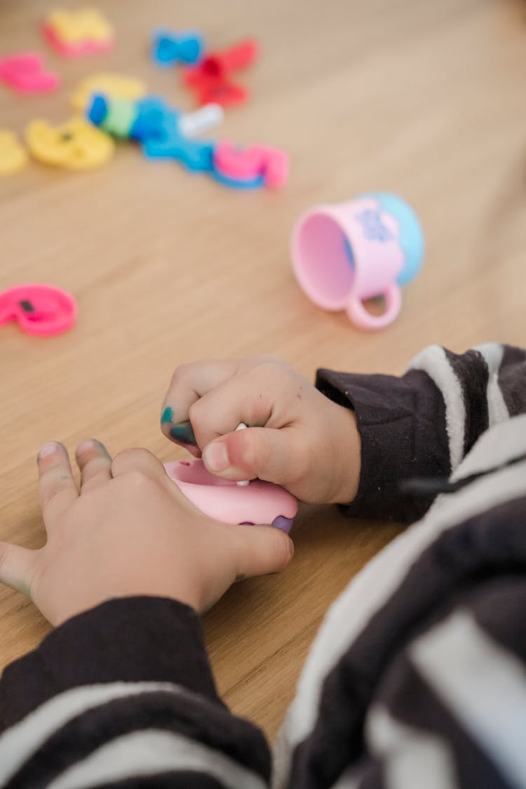 Close-up Of A Child Playing With Toys 