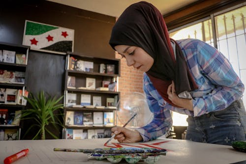 A Woman Painting on the Table