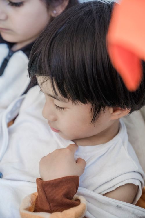 Free A close-up image showing a child looking away, capturing innocence and curiosity. Stock Photo