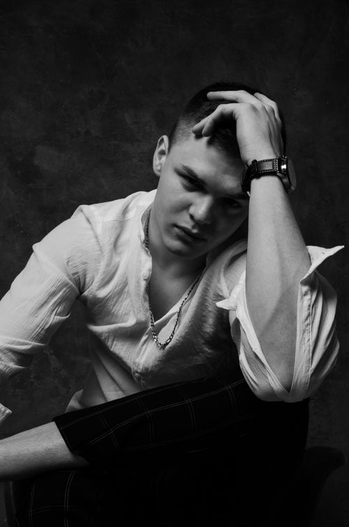 Free Artistic black and white portrait of a young man in thought. Stock Photo