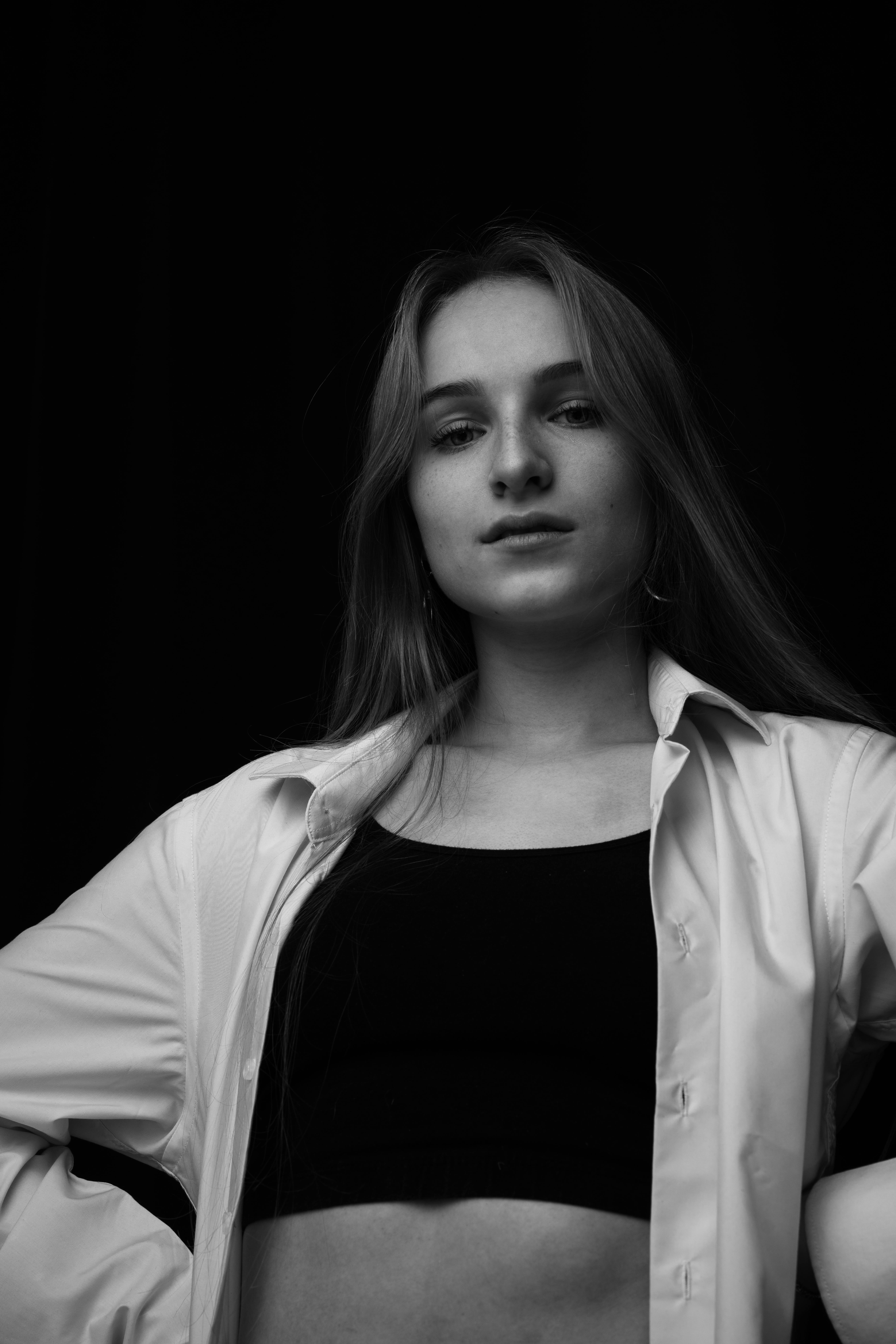 Artistic grayscale portrait of a woman posing with a confident expression.