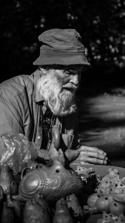Grayscale Photo of a Bearded Elderly Man with a Bucket Hat