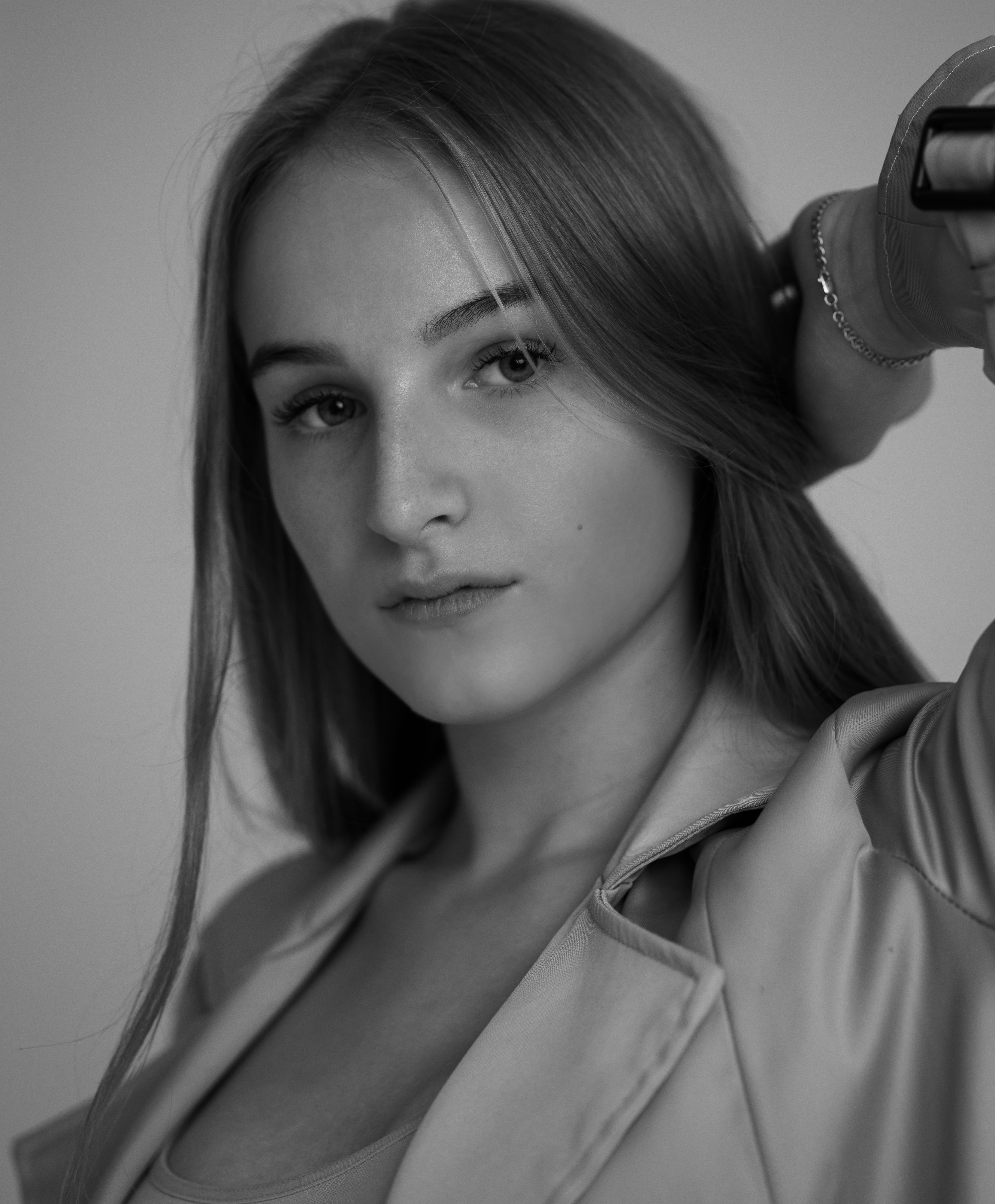 Stylish black and white portrait of a woman showcasing natural beauty and grace.