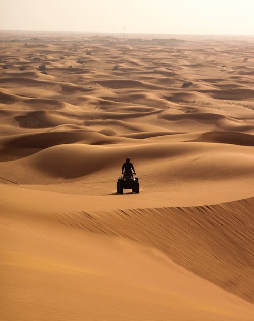 Free Photo of a Person Riding an ATV on Desert Stock Photo