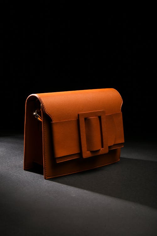Free Photo of a Brown Leather Bag on Black Surface Stock Photo